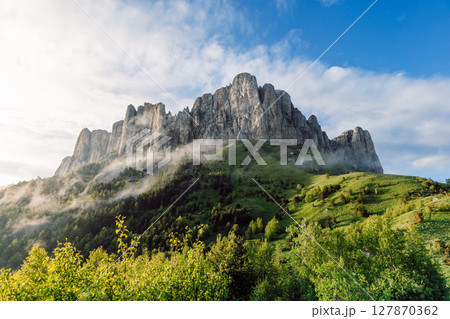 Park Bolshoy Tkhach mount with fog, sky and sunlight. Caucasus Mountains in Russia Park Bolshoy Tkhach mount with fog, sky and sunlight. Caucasus Mountains in Russia 127870362