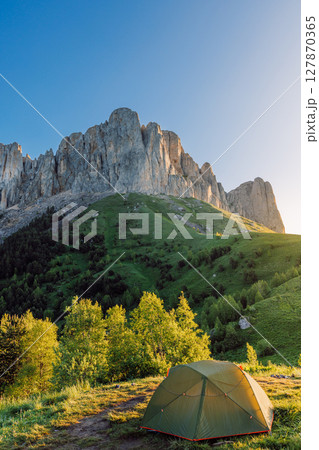 Camping spot in the mountains with a tent at sunrise, Bolshoy Tkhach national park in Caucasus Camping spot in the mountains with a tent at sunrise, Bolshoy Tkhach national park in Caucasus 127870365