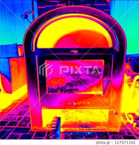 Blazing fire inside a fireplace stove. Thermal photography Blazing fire inside a fireplace stove. Thermal photography 127871102