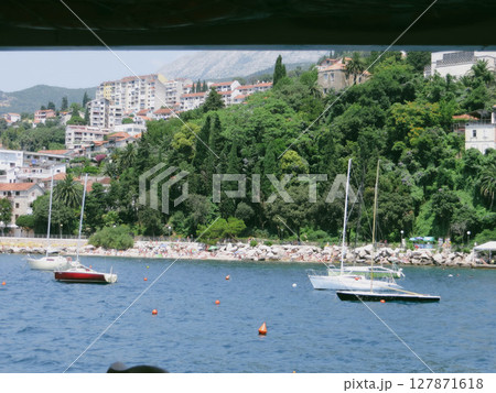 Scenic View of Herceg Novi Beach With Boats in the Tranquil Waters of Boka Kotorska Bay 127871618