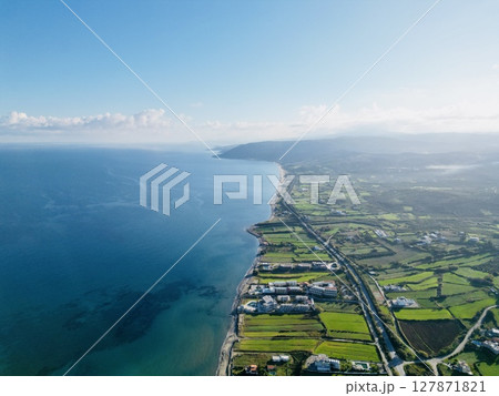 Cretan spring. View of turquoise sea and green fields 127871821