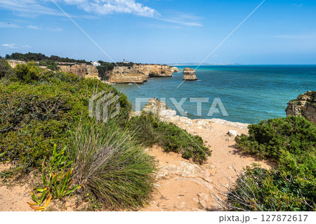 Praia da Marinha Beach among rock islets and cliffs seen from Seven Hanging Valleys Trail, Algarve, Portugal Praia da Marinha Beach among rock islets and cliffs seen from Seven Hanging Valleys Trail, Algarve, Portugal 127872617