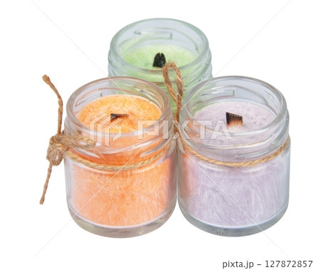 multicolored scented candles in transparent jars on a white background 127872857