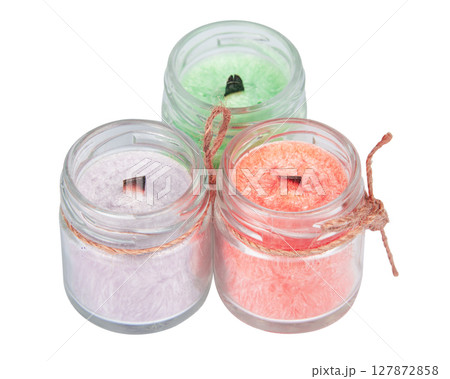 multicolored scented candles in transparent jars on a white background multicolored scented candles in transparent jars on a white background 127872858