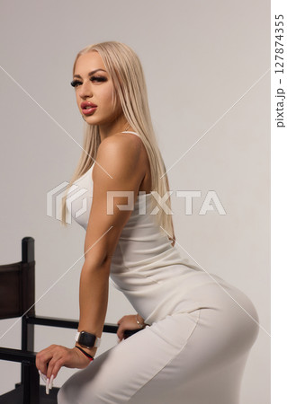 An Elegant Fashion Model Pose in a Chic and Stylish Dress for a Stunning Photoshoot An Elegant Fashion Model Pose in a Chic and Stylish Dress for a Stunning Photoshoot 127874355