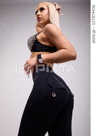 A Stylish Model is Posing Elegantly in a Trendy and Fashionable Outfit for the Camera 127874430