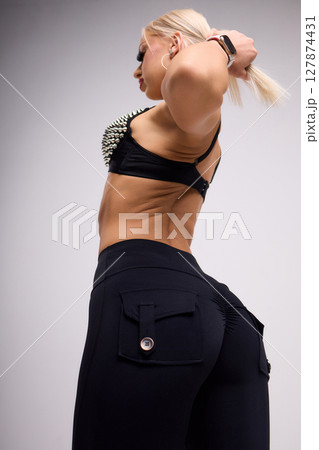 A Stylish Model is Posing Elegantly in a Trendy and Fashionable Outfit for the Camera 127874431
