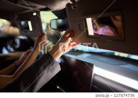 The modern car interior features a sleek vanity mirror that highlights both functionality and style The modern car interior features a sleek vanity mirror that highlights both functionality and style 127874736