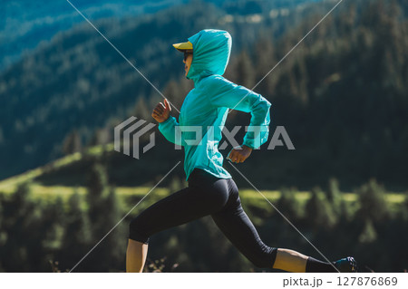 Fitness asian woman runner running at sunrise grassland Fitness asian woman runner running at sunrise grassland 127876869