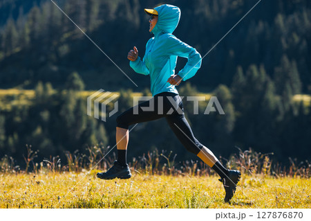 Fitness asian woman runner running at sunrise grassland 127876870