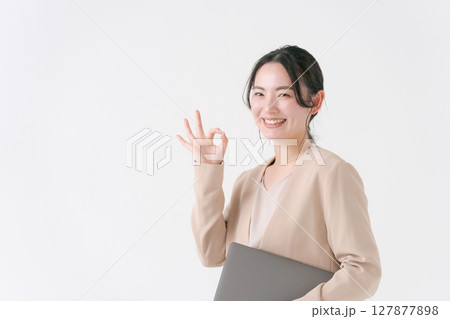 パソコンを持つスーツの女性 127877898