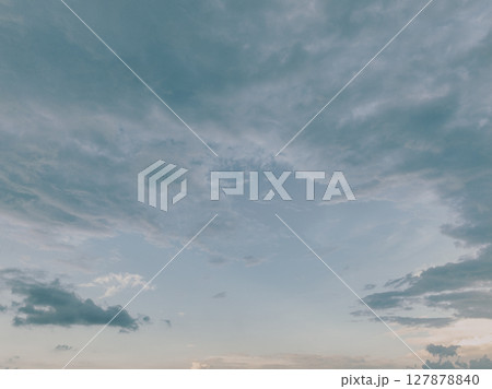 Dramatic overcast sky with gray fluffy clouds creating peaceful yet moody atmospheric background perfect for weather forecasting and emotional design materials. Serene overcast cloudscape. Dramatic overcast sky with gray fluffy clouds creating peaceful yet moody atmospheric background perfect for weather forecasting and emotional design materials. Serene overcast cloudscape. 127878840