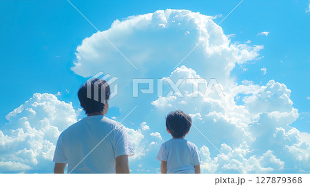 夏の空の入道雲を見上げる父親と子どもの後ろ姿 127879368