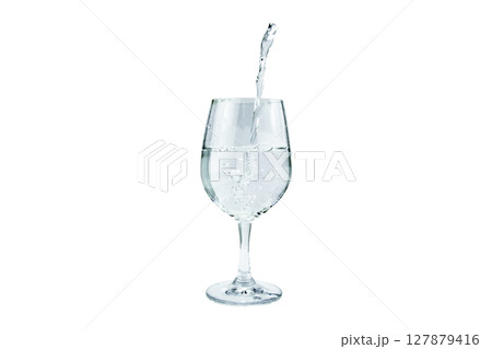 Water poured into a wine glass on an isolated background Water poured into a wine glass on an isolated background 127879416