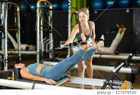 trainer helps the client work with the muscles trainer helps the client work with the muscles 127879500