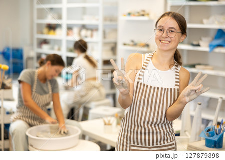 Teenage girl posing in ceramic workshop Teenage girl posing in ceramic workshop 127879898