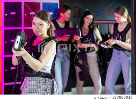 Portrait of happy cheerful girl with laser gun for playing laser tag 127880032