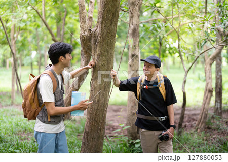 Father and Son Learning Together. Discussing nature during a hike. Father and Son Learning Together. Discussing nature during a hike. 127880053