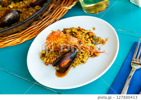 Paella on white plate Paella on white plate 127880413