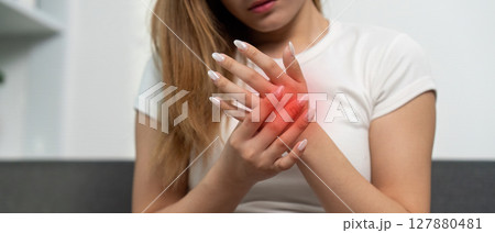 Hand Pain and Discomfort. Young woman experiencing wrist pain at home. Hand Pain and Discomfort. Young woman experiencing wrist pain at home. 127880481