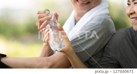 Couple sharing water and smiles during fitness session 127880671
