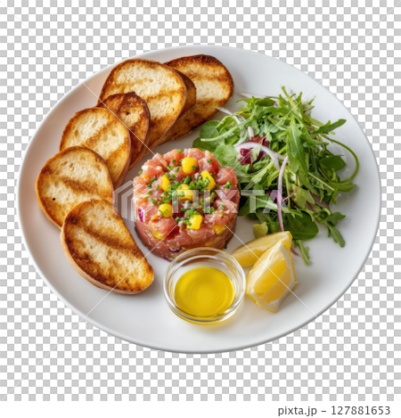 Fresh Tuna Tartare with Crostini, Capers, Red Onion, Lemon Zest, and Olive Oil on a White Plate 127881653