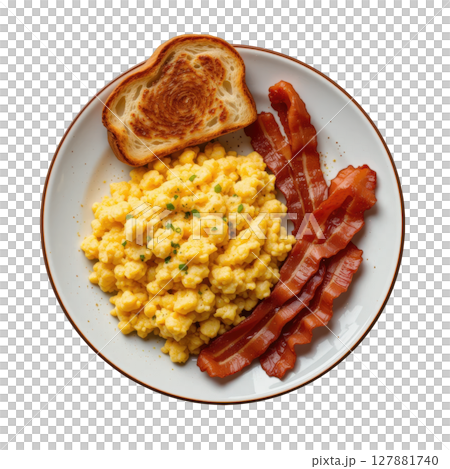 Scrambled eggs with crispy bacon and toasted bread on white plate, classic hearty breakfast meal served warm and delicious 127881740