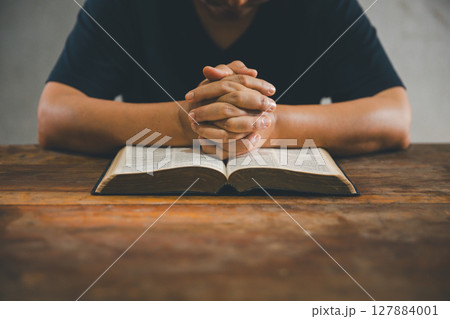 Christian woman reading bible in ancient Catholic temple. Reading Holy Bible in temple. Concept for faith, spirituality and religion. Peace, hope, Christians with holy book for worship and faith 127884001