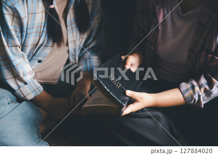 Close up group christians hands pray to God with spiritual faith on holy bible in catholic church. religion worship prayer ask god bless grace jesus believe. Christianity religion prayer holy worship Close up group christians hands pray to God with spiritual faith on holy bible in catholic church. religion worship prayer ask god bless grace jesus believe. Christianity religion prayer holy worship 127884020