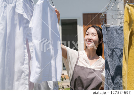 洗濯物を干す女性 127884697