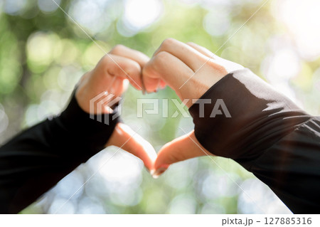 Young woman hand reaching for mountains. Spiritual girl smiling to sky. Happy female being thankful. Spiritual girl praying with hope. Positive asian young woman feeling hope and faith looking up. Young woman hand reaching for mountains. Spiritual girl smiling to sky. Happy female being thankful. Spiritual girl praying with hope. Positive asian young woman feeling hope and faith looking up. 127885316