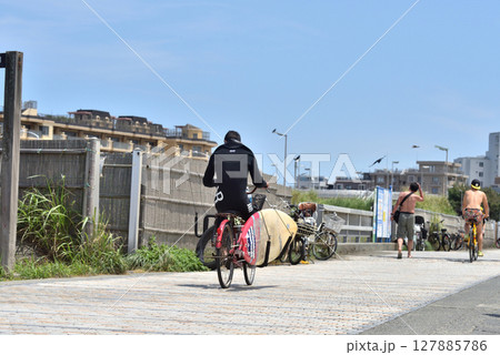 いい波を求めて海岸遊歩道を自転車で移動する人 いい波を求めて海岸遊歩道を自転車で移動する人 127885786