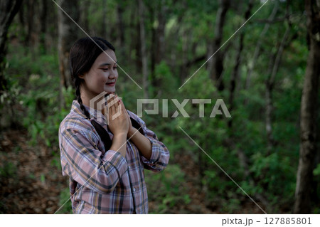 Grateful woman having HOPE praying to God. Spiritual girl smiling to sky. Happy female being thankful. Spiritual girl praying with hope. Positive asian young woman feeling hope and faith looking up. 127885801