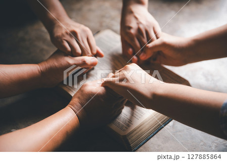 Close up group christians hands pray to God with spiritual faith on holy bible in catholic church. religion worship prayer ask god bless grace jesus believe. Christianity religion prayer holy worship Close up group christians hands pray to God with spiritual faith on holy bible in catholic church. religion worship prayer ask god bless grace jesus believe. Christianity religion prayer holy worship 127885864