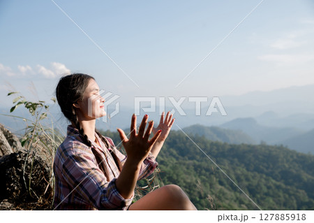Grateful woman having HOPE praying to God. Spiritual girl smiling to sky. Happy female being thankful. Spiritual girl praying with hope. Positive asian young woman feeling hope and faith looking up. 127885918