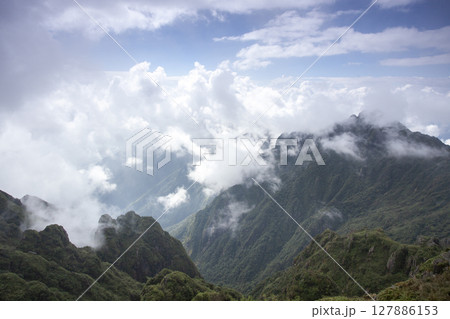 Landscape of Morning Mist with Mountain Layer. mountain ridge and clouds in rural jungle bush forest Landscape of Morning Mist with Mountain Layer. mountain ridge and clouds in rural jungle bush forest 127886153