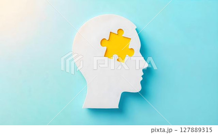 A white silhouette of a human head with a cut-out puzzle piece, representing the intricacies of mental health and personal growth A white silhouette of a human head with a cut-out puzzle piece, representing the intricacies of mental health and personal growth 127889315