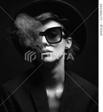 Black and white portrait of Smoking Beautiful woman in sunglasses and Hat 127890160