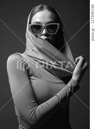 Black and white portrait of Beautiful young woman in sunglasses and hood Black and white portrait of Beautiful young woman in sunglasses and hood 127890196