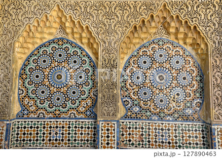 Ornamental and colorful arabesque carvings, mosaic tiles, zellige, medina of Tangier, Morocco Ornamental and colorful arabesque carvings, mosaic tiles, zellige, medina of Tangier, Morocco 127890463