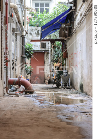 June 29 2025 Narrow Alleyway with Various Equipment and Tarps in Urban Setting June 29 2025 Narrow Alleyway with Various Equipment and Tarps in Urban Setting 127890688