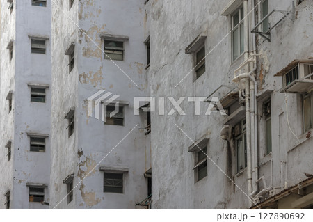 June 29 2025 Urban Apartment Exterior with Peeling Paint and Multiple Small Windows June 29 2025 Urban Apartment Exterior with Peeling Paint and Multiple Small Windows 127890692