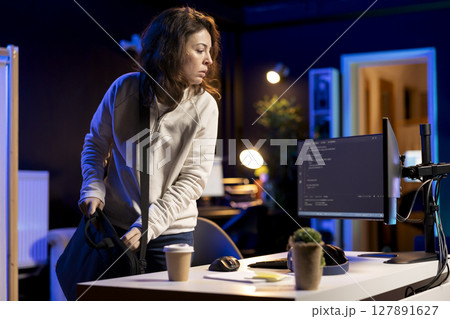 System administrator arriving in office, ready to design and develop software applications on laptop. IT expert starting job shift, unpacking notebook, implementing and maintaining company systems System administrator arriving in office, ready to design and develop software applications on laptop. IT expert starting job shift, unpacking notebook, implementing and maintaining company systems 127891627