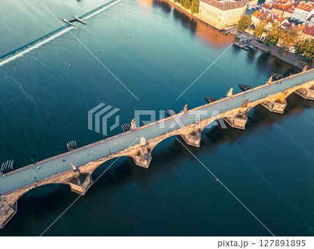Morning light illuminates Charles Bridge in Prague, revealing its historic architecture against the serene waters of the Vltava River. A breathtaking aerial view captures the beauty of the old town. Morning light illuminates Charles Bridge in Prague, revealing its historic architecture against the serene waters of the Vltava River. A breathtaking aerial view captures the beauty of the old town. 127891895