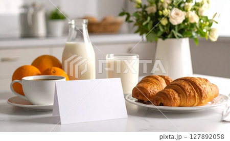 Fresh morning breakfast spread featuring croissants, coffee, and orange juice on a white table Fresh morning breakfast spread featuring croissants, coffee, and orange juice on a white table 127892058