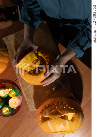 Creating Halloween Decorations by Carving Pumpkins and Preparing for the Holiday Festivities 127892352