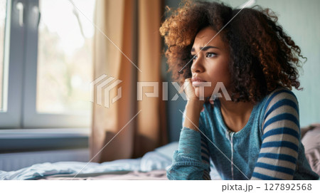 Woman in Deep Thought Holding Her Head in Frustration 127892568