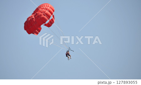 parasailing with red parachute 127893055