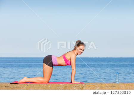 Woman with water after workout 127893810