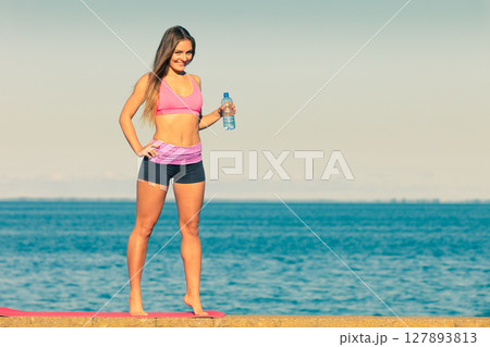 Woman drinking water after sport gym outdoor 127893813